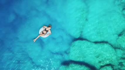Wall Mural - aerial view at the girl on sea surface. beautiful composition at the summer time