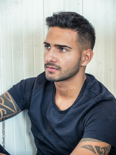 Handsome Green Eyed Young Man Relaxing At Home Sitting On His
