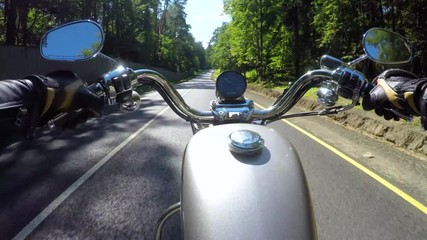 Wall Mural - Riding a motorcycle. Biker rides on the road with a first-person.