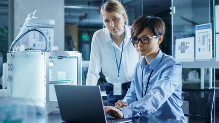 Wall Mural - two engineers work with three dimensional printer in laboratory