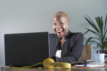 young attractive and happy successful black afro american woman in business jacket working cheerful at office laptop computer desk smiling satisfied