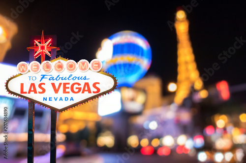 Famous Las Vegas sign with blur cityscape Wallpaper Mural