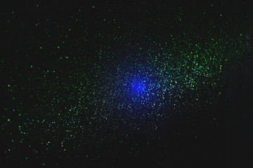 green sparkling and shining star points on a black isolated background and a blue bright flash will 