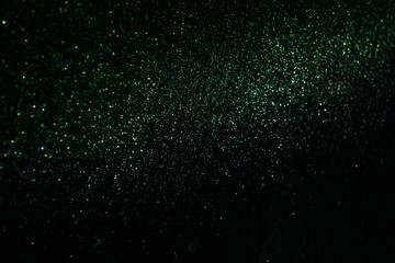 green sparkling and shining star points on a black isolated background will create a festive mood