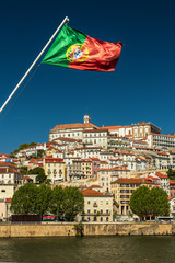 Canvas Print - Coimbra, Portugal, on a sunny day, with blue skies, with the Portuguese flag on top and the river Mondego on the bottom.