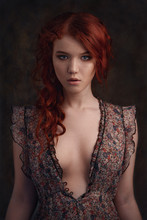 Dramatic Retro Portrait Of A Young Beautiful Dreamy Redhead Woman. Soft Vintage Toning.