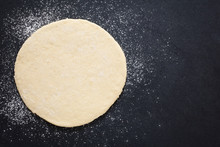 Rolled Out Pizza Dough On Floured Slate Surface, Photographed Overhead With Natural Light