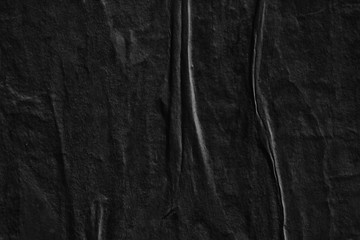 Dark black grey creased crumpled paper background surface old torn ripped posters scary grunge texture backdrop   