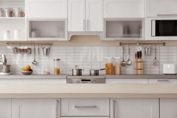 Poster - Countertop and blurred view of kitchen interior on background