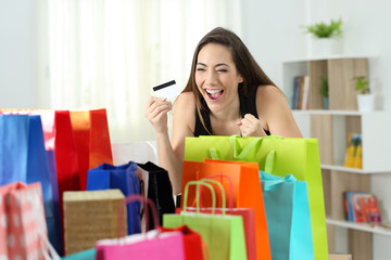 Wall Mural - Excited shopper looking at multiple purchases