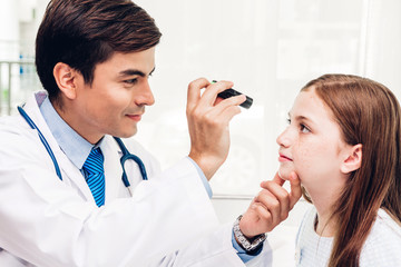 Doctor checking and examination on eye with little girl child in hospital.healthcare and medicine