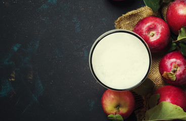 Wall Mural - Apple cider in beer glass with fresh apples, black background, top view