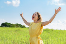 Happy Young Woman Is Singing With Closed Eyes And Raising Her Hands