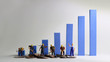 The miniature workers standing on a blue bar graph. Minimum wage increase concept.