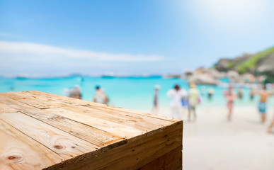 Aufkleber - Empty wood plank table food stand with blur tourist on sand beach for summer vacation with bokeh light background,Template mock up for display or montage of product.