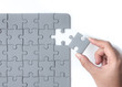 © showcake - Hand put the last piece of jigsaw puzzle, success, teamwork and finishing or ending