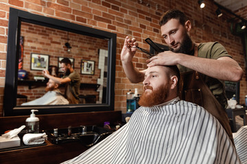 Barber and bearded man in barber shop