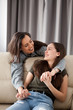© DC Studio - Two happy and fun sisters in the living room. Lifestyle image