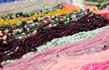 Wall Mural - Many necklaces of pearls on sale in the stand of costume jewelry