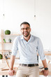 © Drobot Dean - Happy portrait of businesslike man wearing white shirt sitting on table in office, and smiling at camera