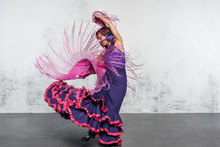 Flamenco Dancer In Action With The Typical Spanish Dance Costume.