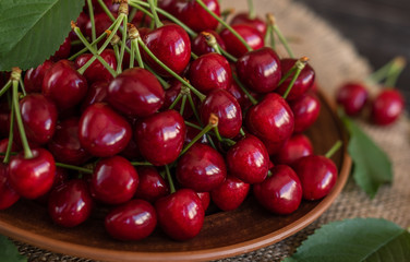 Tasty juicy sweet cherry on a wooden background. It can be used as a background