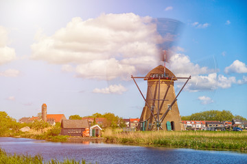 Wall Mural - Famous windmills in Kinderdijk village in Holland. Spinning windwill. Colorful spring landscape in Netherlands, Europe. UNESCO World Heritage and famous tourist site.