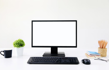 Wall Mural - front view blank screen Computer with mouse, keyboard,pencils and tree vase in Modern office