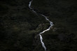 © Michael Schauer - Dark forest with waterfall on the side of a mountain in Norway