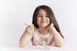 © kaganskaya115 - Happy child girl eating ice cream in white and chocolate bowl on white background. Enjoying delicious.