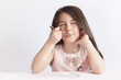 © kaganskaya115 - Happy child girl eating ice cream in white and chocolate bowl on white background. Enjoying delicious.