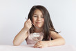 © kaganskaya115 - Happy child girl eating ice cream in white and chocolate bowl on white background. Enjoying delicious.