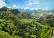 Cape Verde. Gorgeous Panoramic View Of Famous Fertile Paul Valley. Agriculture Terraces Of Sugarcane In Vertical Valley Sides, People Dwellings, Rugged Peaks And Motion Clouds On Horizon