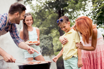 Wall Mural - Young family make barbecue at their home