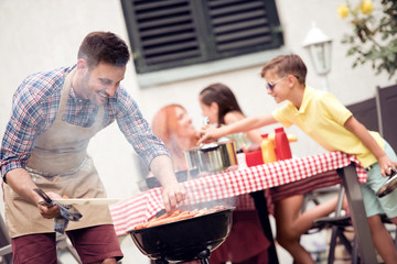 Wall Mural - Young family make barbecue at their home