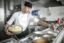 Chinese Chef Cooking In A Restaurant Kitchen
