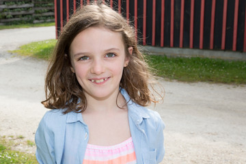 cheerful brunette kid girl outdoor in sun summer