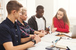 © Prostock-studio - Group of diverse students studying at wooden table