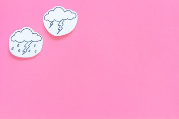 Wall Mural - rainfall forecast concept. weather icons. rainy cloud, lightening on pink background top view copy s