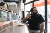 Fototapeta  - Bearded man who drinks beer in a bar in Madrid city