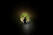 Child Sitting in Tunnel