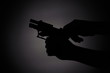 © Markus - black silhouette of a male reloading a gun in the dark