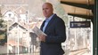 © EuStock - Businessman With Newspaper in Hand Waiting Train Arrival Railway Station