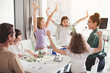 © Yakobchuk Olena - We did it. Laughing children gesticulating hands while looking at robot. Happy woman keeping it in hand