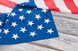 American pride United States flag. Crumpled flag of USA on vintage wooden boards with text space.