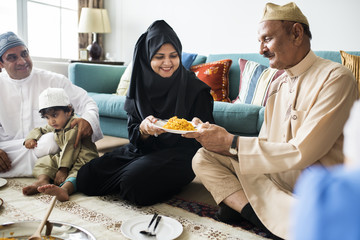 Wall Mural - Muslim family having dinner on the floor