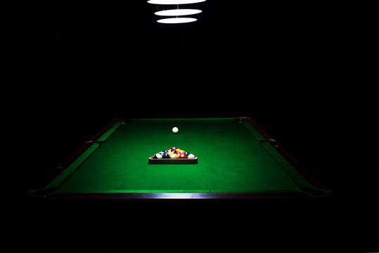 Fototapete - Game of billiards on a table with green cloth 