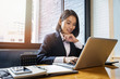 © skarie - Closeup of businesswoman using laptop at office desk. She searching web or browsing information.