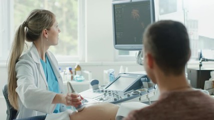 Wall Mural - In the Hospital, Female Obstetrician Puts Gel on the Belly of a Pregnant Mother, Ready to do Ultrasound Screening. Happy Family. Shot on RED EPIC-W 8K Helium Cinema Camera.