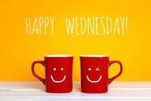 Two Red Coffee Mugs With A Smiling Faces On A Yellow Background  With The Phrase Happy Wednesday.